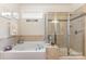 This bathroom features a walk-in shower, a soaking tub and tile at 2035 Moultrie Ct, Fort Mill, SC 29707