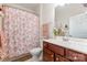 This bathroom features a single vanity, ceramic toilet, and floral shower curtain at 2035 Moultrie Ct, Fort Mill, SC 29707