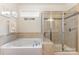 This bathroom features a walk-in shower, a soaking tub and tile at 2035 Moultrie Ct, Fort Mill, SC 29707
