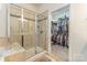 This bathroom features a tile walk-in shower and access to a walk-in closet at 2035 Moultrie Ct, Fort Mill, SC 29707