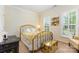 This bedroom features natural light, a golden bed frame, and nice wall art at 2035 Moultrie Ct, Fort Mill, SC 29707