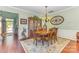 Elegant dining room with hardwood floors, a large table, a hutch, and a view into the foyer at 2035 Moultrie Ct, Fort Mill, SC 29707