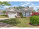 Charming home featuring a two-car garage, tidy lawn, and colorful landscaping on a sunny day at 2035 Moultrie Ct, Fort Mill, SC 29707
