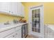 Convenient laundry room with sink, cabinetry, and access to the outdoors at 2035 Moultrie Ct, Fort Mill, SC 29707
