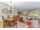 Open-concept living room and dining area with hardwood floors, fireplace, and ample natural light at 2035 Moultrie Ct, Fort Mill, SC 29707