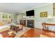 Inviting living room with fireplace, TV, hardwood floors, and stylish decor at 2035 Moultrie Ct, Fort Mill, SC 29707