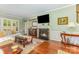 Comfortable living room features a fireplace, hardwood floors, and a view into the dining room at 2035 Moultrie Ct, Fort Mill, SC 29707