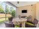 Relaxing screened patio with comfortable seating and a mounted TV for outdoor entertainment at 2035 Moultrie Ct, Fort Mill, SC 29707