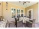 Inviting outdoor patio space with wicker furniture, ceiling fan and screened windows at 2035 Moultrie Ct, Fort Mill, SC 29707