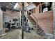 Unfinished basement with brick walls and staircase provides ample storage and creative potential at 2124 Chambwood Dr, Charlotte, NC 28205