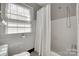 Classic bathroom with tiled walls, shower-tub combination, and bright natural light at 2124 Chambwood Dr, Charlotte, NC 28205