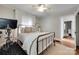 Serene bedroom featuring a plush bed, light-colored rug, exercise bike, and soothing decor at 2124 Chambwood Dr, Charlotte, NC 28205