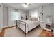 Comfortable bedroom showcasing a metal bed frame, neutral bedding, and hardwood floors at 2124 Chambwood Dr, Charlotte, NC 28205