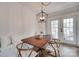 Inviting dining room with a wooden table, bench seating, and modern light fixture at 2124 Chambwood Dr, Charlotte, NC 28205