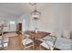 Elegant dining area featuring a wood table, cozy bench, and modern light fixture at 2124 Chambwood Dr, Charlotte, NC 28205
