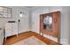 Inviting entryway boasts hardwood floors, neutral walls, and an antique cabinet adding character at 2124 Chambwood Dr, Charlotte, NC 28205