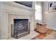 Elegant fireplace with a decorative screen, mantle, and hearth complemented by hardwood flooring at 2124 Chambwood Dr, Charlotte, NC 28205