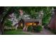 Quaint brick home with covered porch and lush greenery provides a welcoming and serene setting at 2124 Chambwood Dr, Charlotte, NC 28205