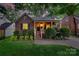 Charming brick home with a cozy front porch and manicured landscaping creating lovely curb appeal at 2124 Chambwood Dr, Charlotte, NC 28205
