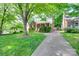 Charming single-story brick home with manicured lawn and inviting front porch at 2124 Chambwood Dr, Charlotte, NC 28205