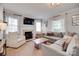 Bright living room with a fireplace, large sectional sofa, and natural light from the large window at 2124 Chambwood Dr, Charlotte, NC 28205