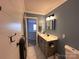 This bathroom features a single sink, vanity, and marble floors at 2330 Winthorp Ridge Rd, Charlotte, NC 28270