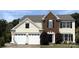 Two story home with a two car garage, brick facade, and manicured lawn at 2330 Winthorp Ridge Rd, Charlotte, NC 28270