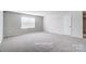 Carpeted bedroom featuring large window and closet at 2522 Mabel Ln, Monroe, NC 28110
