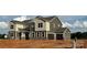 Charming two-story home featuring a two-car garage and a mix of stone and siding accents at 2522 Mabel Ln, Monroe, NC 28110