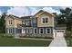 Craftsman elevation home with two-tone siding, stone accents, manicured lawn, and an attached two-car garage at 2522 Mabel Ln, Monroe, NC 28110