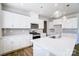 Bright kitchen features white cabinets, stainless steel appliances, and an island with quartz countertops at 2522 Mabel Ln, Monroe, NC 28110