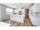 Open concept kitchen featuring modern appliances, white cabinets, a large island, and bright natural light at 2522 Mabel Ln, Monroe, NC 28110