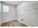 Laundry room featuring wood-look floors and a wire storage rack at 2522 Mabel Ln, Monroe, NC 28110