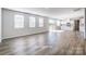 Bright, open-concept living room featuring wood-look flooring and ample natural light at 2522 Mabel Ln, Monroe, NC 28110