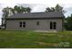 Backyard view of home with dark siding and a sliding glass door at 3011 Buffett Ln # 33, Monroe, NC 28110