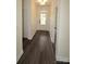 Bright hallway with wood-look flooring, board and batten trim, and natural light through the front door at 3011 Buffett Ln # 33, Monroe, NC 28110