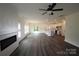 Spacious living room and kitchen featuring an open layout, modern fireplace, and wood-look flooring at 3011 Buffett Ln # 33, Monroe, NC 28110