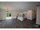 Open-concept living room with kitchen, showcasing an island, stainless appliances, and sliding doors to the yard at 3011 Buffett Ln # 33, Monroe, NC 28110