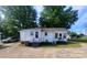 Rear exterior view featuring dual entrances, quaint stairs, and spacious parking at 309 E 11Th St, Kannapolis, NC 28083