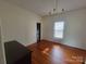 Cozy bedroom featuring hardwood floors, a window, a closet door, and neutral walls at 309 E 11Th St, Kannapolis, NC 28083