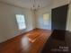 Bright bedroom featuring hardwood floors, two windows, closet door, and neutral walls at 309 E 11Th St, Kannapolis, NC 28083