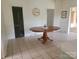 Dining room area featuring a large oval table, tile floors, and neutral paint at 309 E 11Th St, Kannapolis, NC 28083