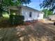 Side angle of home with a covered porch, tidy landscaping, and spacious driveway at 309 E 11Th St, Kannapolis, NC 28083