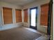 Sunroom featuring a doorway and multiple windows covered with bamboo blinds at 309 E 11Th St, Kannapolis, NC 28083