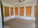 Bright sunroom with multiple windows, bamboo shades, and a ceiling fan at 309 E 11Th St, Kannapolis, NC 28083