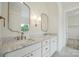 Bathroom with double sinks, marble countertops, elegant mirrors, and brass fixtures at 3622 E Brief Rd, Monroe, NC 28110