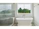 Elegant bathroom featuring a freestanding tub, marble shower, and scenic window view at 3622 E Brief Rd, Monroe, NC 28110