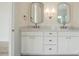 Bathroom featuring double sinks with marble countertops, sconce lighting, and modern fixtures at 3622 E Brief Rd, Monroe, NC 28110