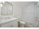 Bright bathroom featuring white tiled shower/tub combo, white vanity, and modern fixtures at 3622 E Brief Rd, Monroe, NC 28110