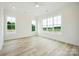 Bright bedroom featuring hardwood floors, white walls, recessed lighting and many windows for natural light at 3622 E Brief Rd, Monroe, NC 28110
